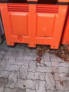 damaged orange plastic bin